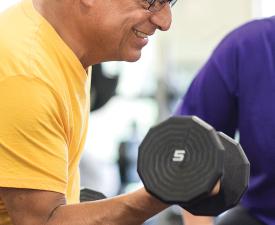 older man lifting weights